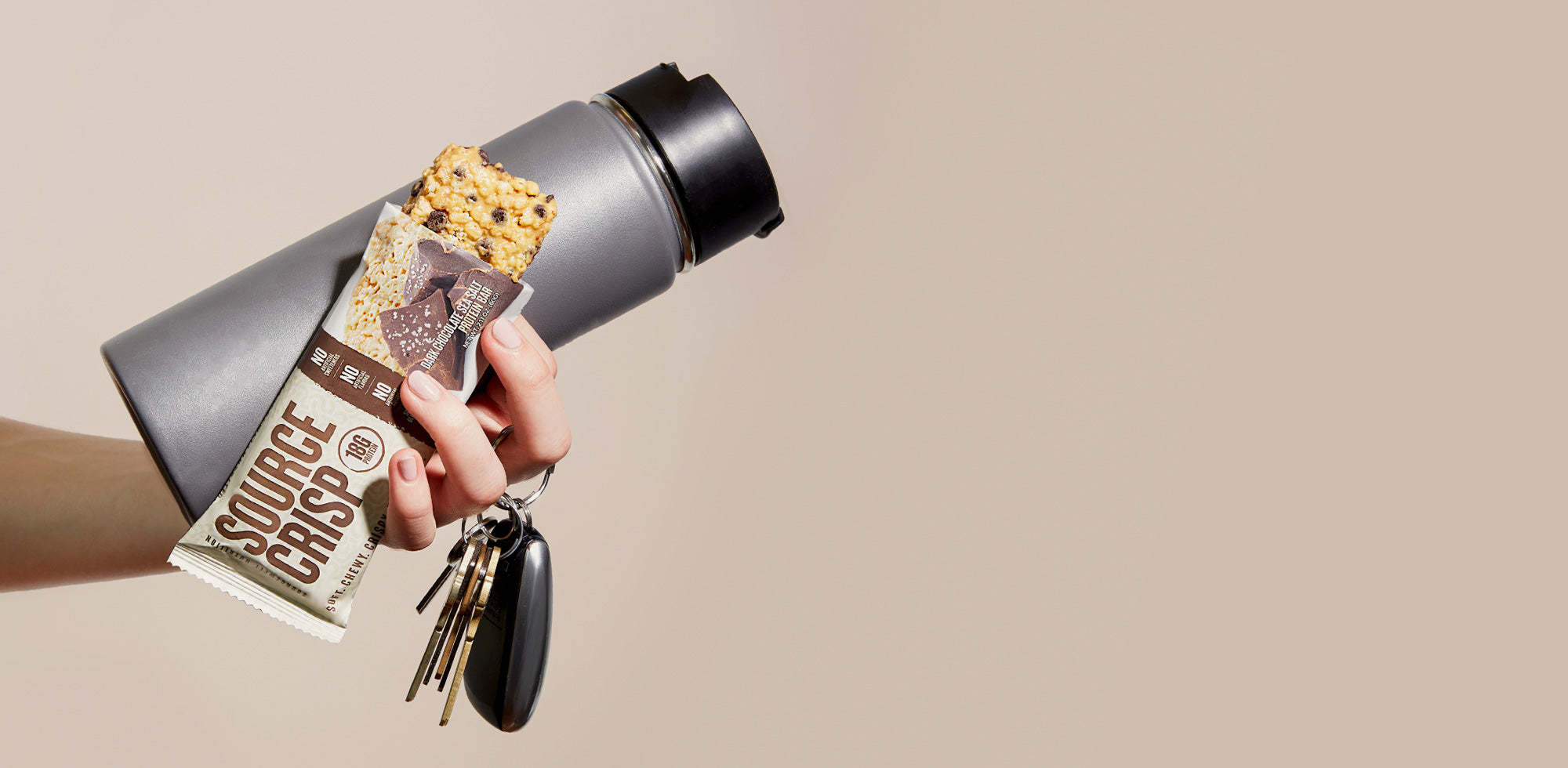 Woman holding Source Crisp protein bar